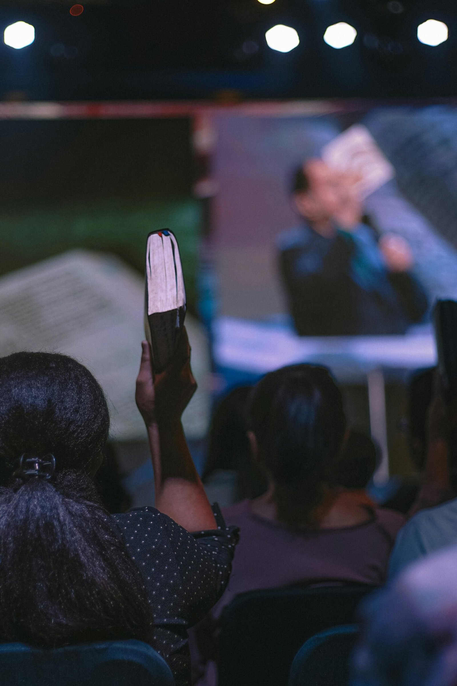 Audience member raises a book during a public event in Jakarta, Indonesia.